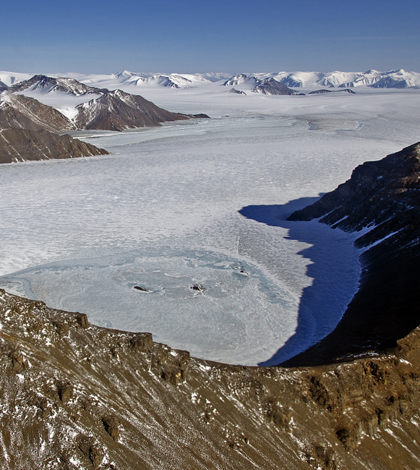 Glaciers flowing through a valley in northeast Greenland seen from NASA's P-3B research aircraft on Apr. 19, 2013. (Credit: NASA/Michael Studinger)