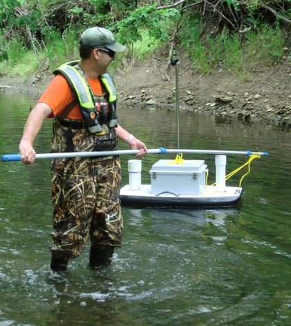 The bodyboard sensor platform needed some help passing slow spots of Indian Creek (Credit: Gary Foster/USGS)