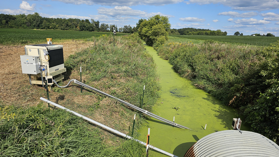 One type of station set-up, showing a radar water level sensor, weather station, water sampler, nutrient analyzer, and sondes for temperature, turbidity, conductivity, soil moisture and rainfall.