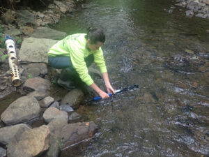 Elk County Conservation District Watershed Technician, Micaela, is rinsing the sonde to remove any silt buildup prior to cleaning and calibration.