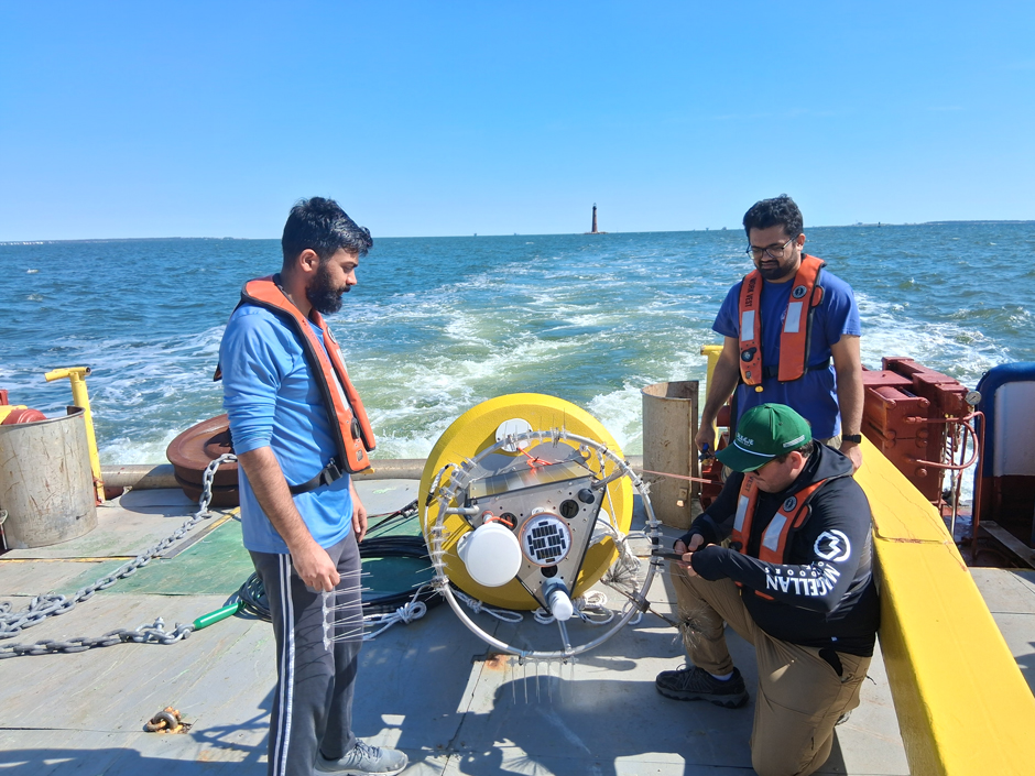 AJ Stewart, Dauphin Island Sea Lab Technician, affixing bird spikes to the buoy tower.