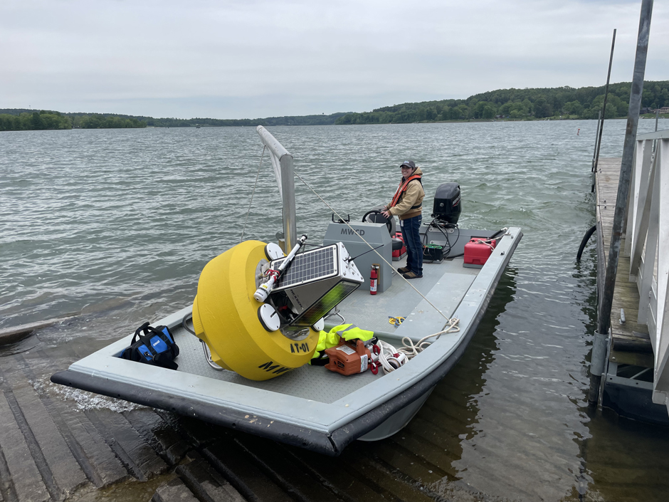 Bailey Miller on RV Beaver at Atwood Lake, preparing to deploy data buoy AT-01.
