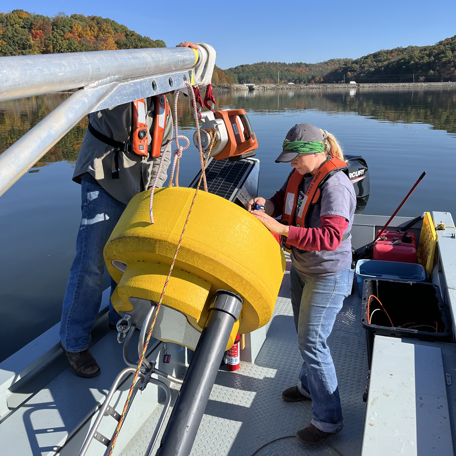 Matt Thomas and Kathryn Hamman activating sensors in data buoy TN-01 before it is deployed at Tappan Lake.