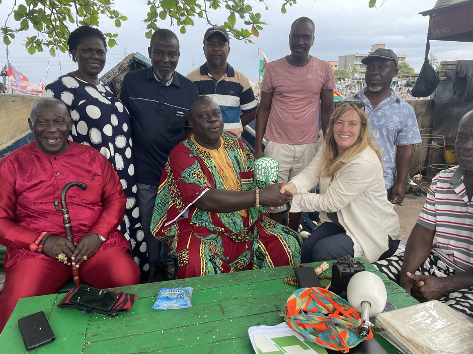 Melissa presents the fisher chiefs and canoe owners with the GPS beacons.