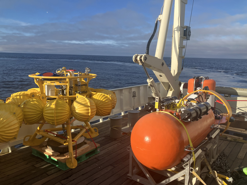 An ocean bottom tripod (yellow, left) and a Stablemoor buoy (red, right). The Stablemoor buoy is a portion of the “Variable Ballast Buoy” system in which an instrument package (not shown) moves vertically depending on how deep the ice is above this Stablemoor buoy. The ice thickness is calculated using the upward-looking ADCP on the Stablemoor.