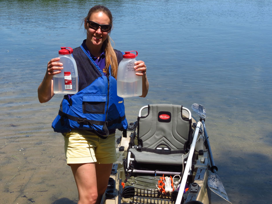 A volunteer returns to shore after collecting samples of lake water for total phosphorus and chlorophyll analysis.