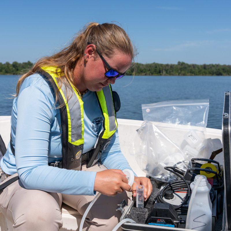 A District scientist conducts water quality sampling.