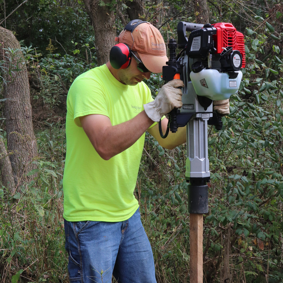 Using post-pounders in areas with larger cobble and difficult substrate for hand tools.