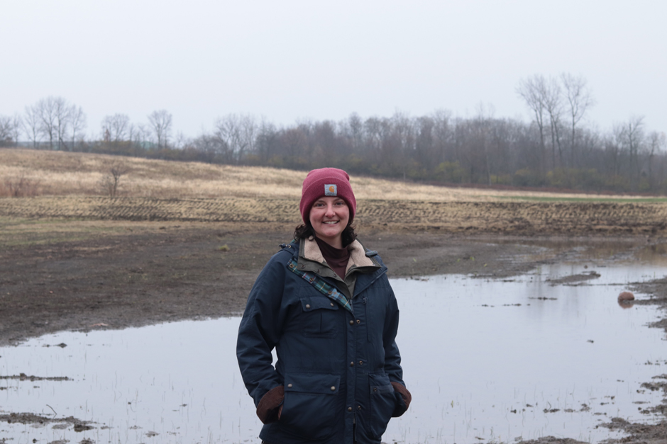 Michelle Pressel, Restoration Ecologist, standing in front of one of the 39 restored wetlands.