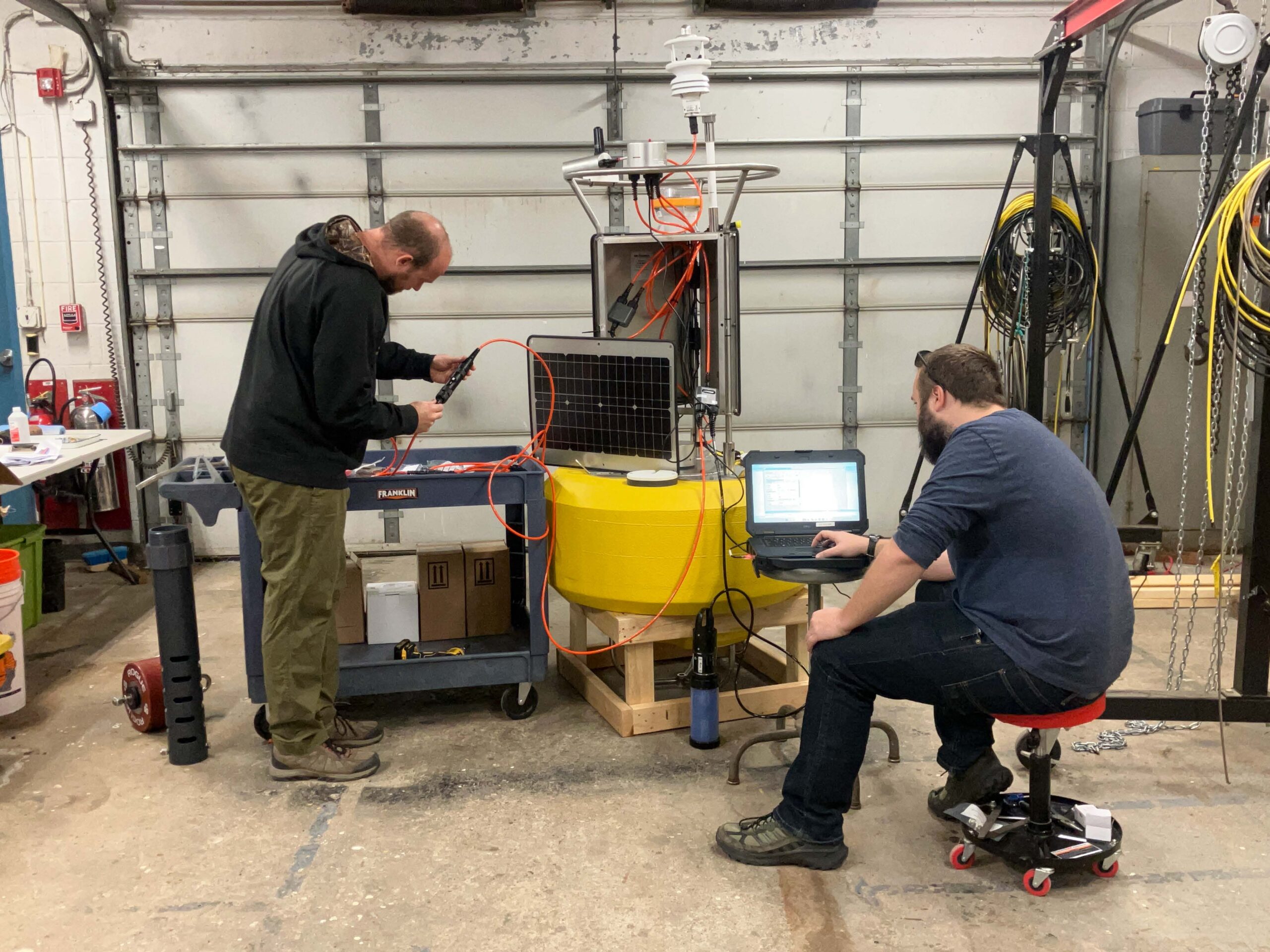 Brian (left) and Ben (right), configuring sensors on the new buoy.