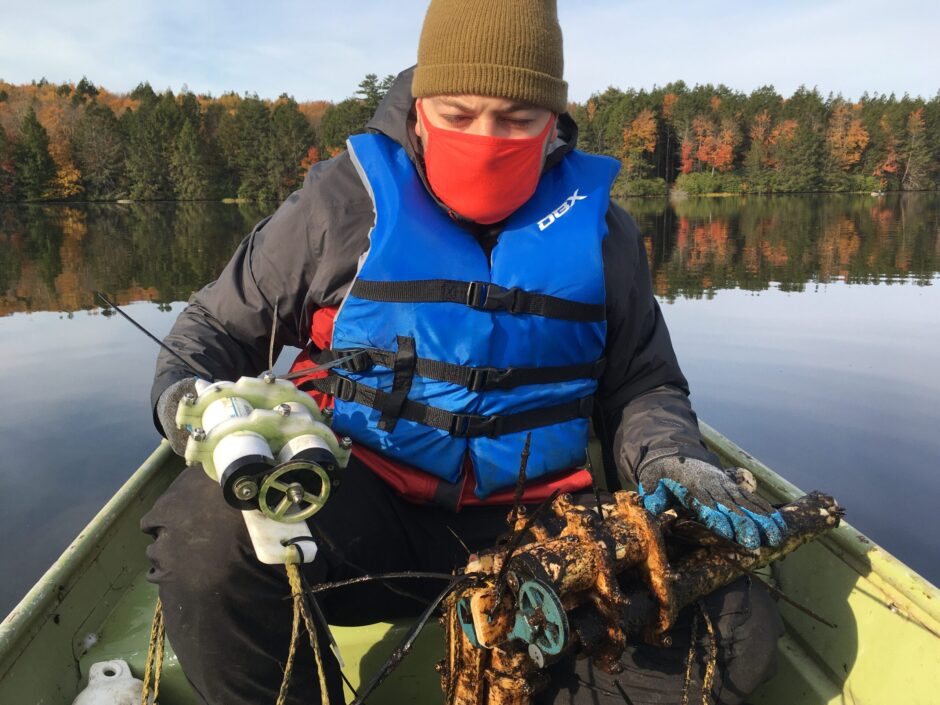 Dr. Jonathan Stetler with sensors retrieved from two different depths in Lake Waynewood. The sensors on the left were located in the deep anoxic (oxygen-free) waters where no algal biomass accumulated. The sensors on the right were located close to the surface where dissolved oxygen supported substantial algal growth.